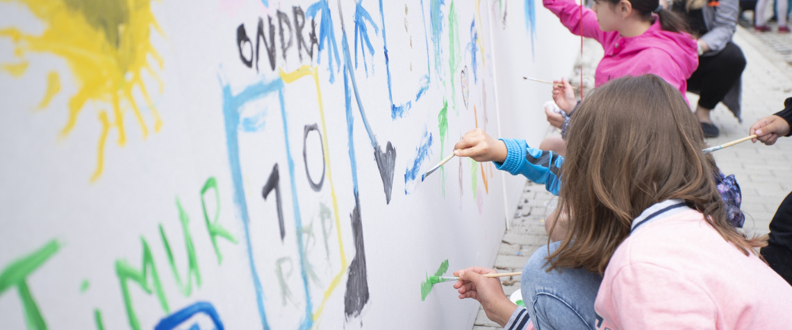 Neighbours spending time together as a work of art is ceremoniously unveiled