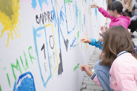 Neighbours spending time together as a work of art is ceremoniously unveiled